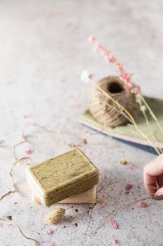 Handcrafted soap bars with dried flowers and twine, perfect for a spa-like self-care routine.